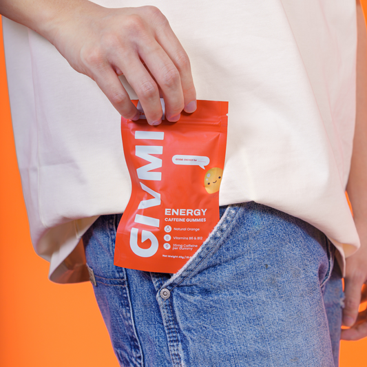 Person slipping a pouch of GIVMI ENERGY sugar-free caffeine gummies into their jeans pocket, showcasing its portability and on-the-go convenience.